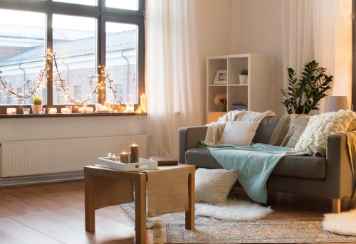 window sill with candles, decorative plants, and fairy lights