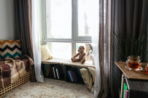 window bench used as a cosy reading lounge and storage