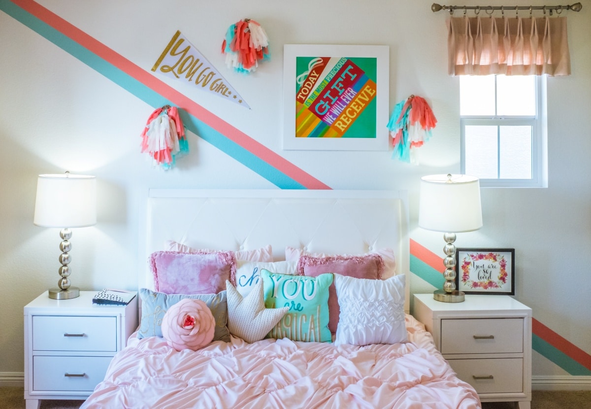 Bedroom with bright blue and pink wall accents