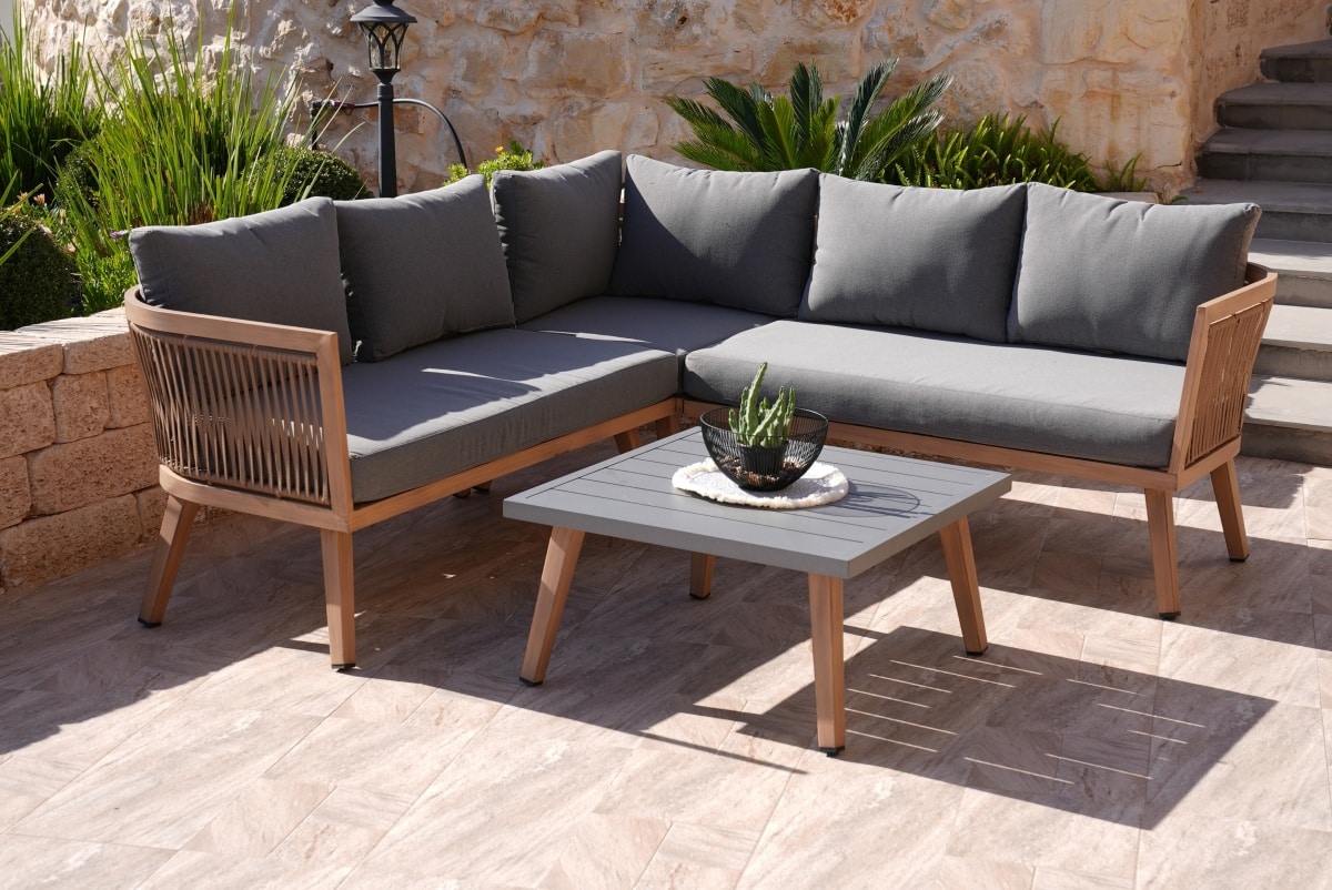 wooden corner sofa with gray pillows and table in garden