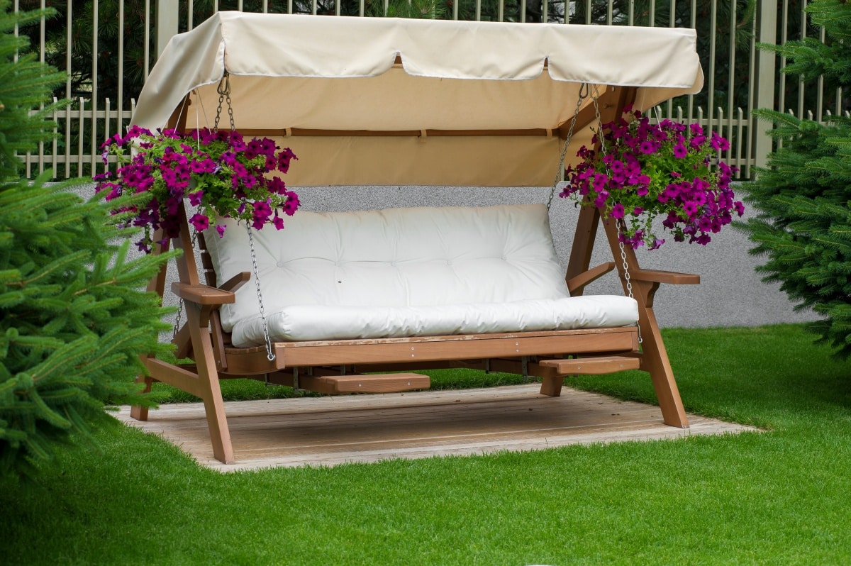 Wooden swing chair in a garden