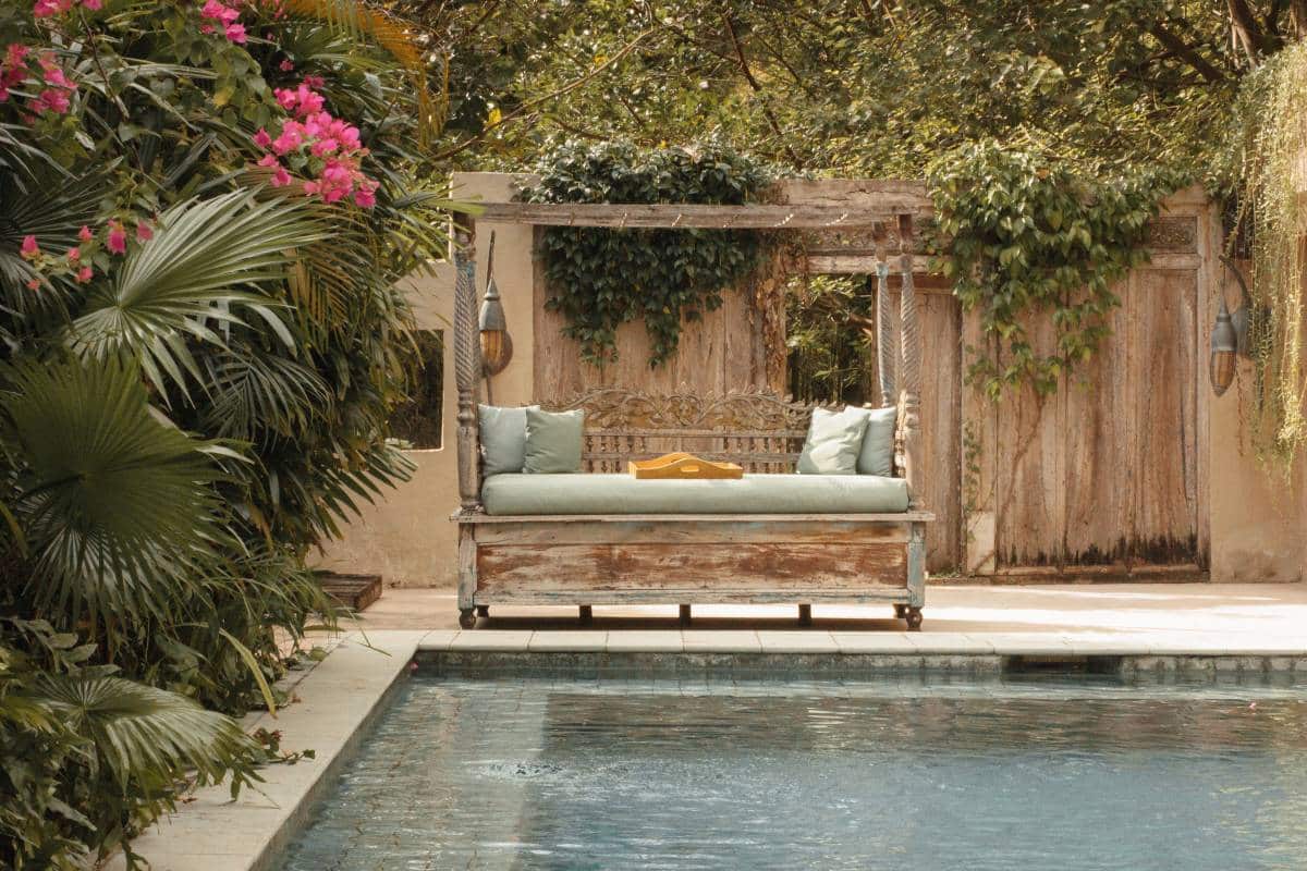wooden garden bed on patio near the edge of a swimming pool