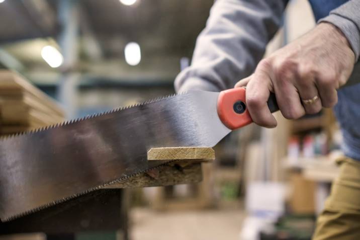 Sawing or cutting a wooden board with special Japanese hand saw