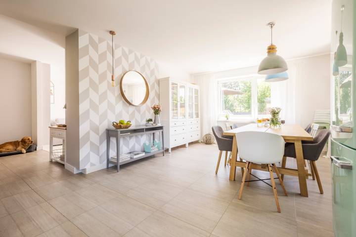 Dining area in apartment with patterned wallpaper.