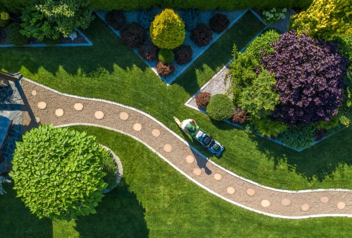 a gardener mowing a lawn