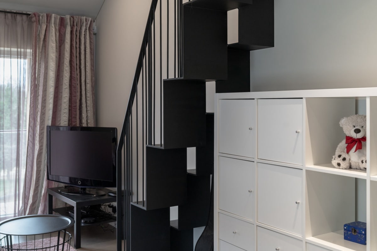 white cabinet with teddy bear near stairs