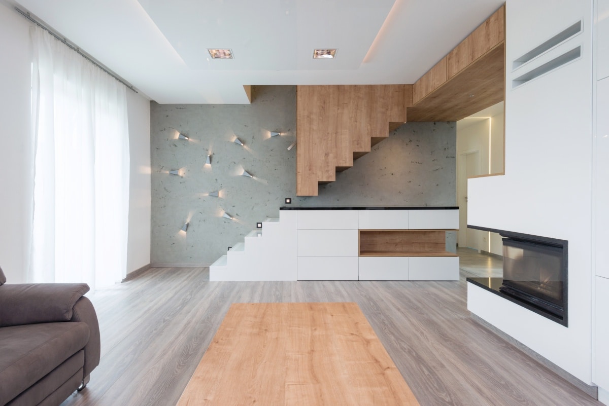 interior of beautiful modern living room with stairway and fireplace