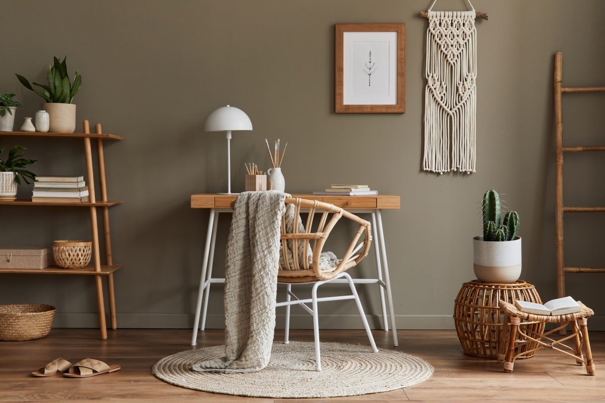 wooden desk, rattan chair, and macrame wall hang