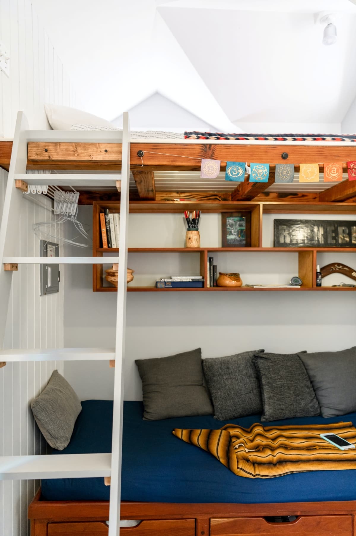 blue and white bed pillows on lofted bed