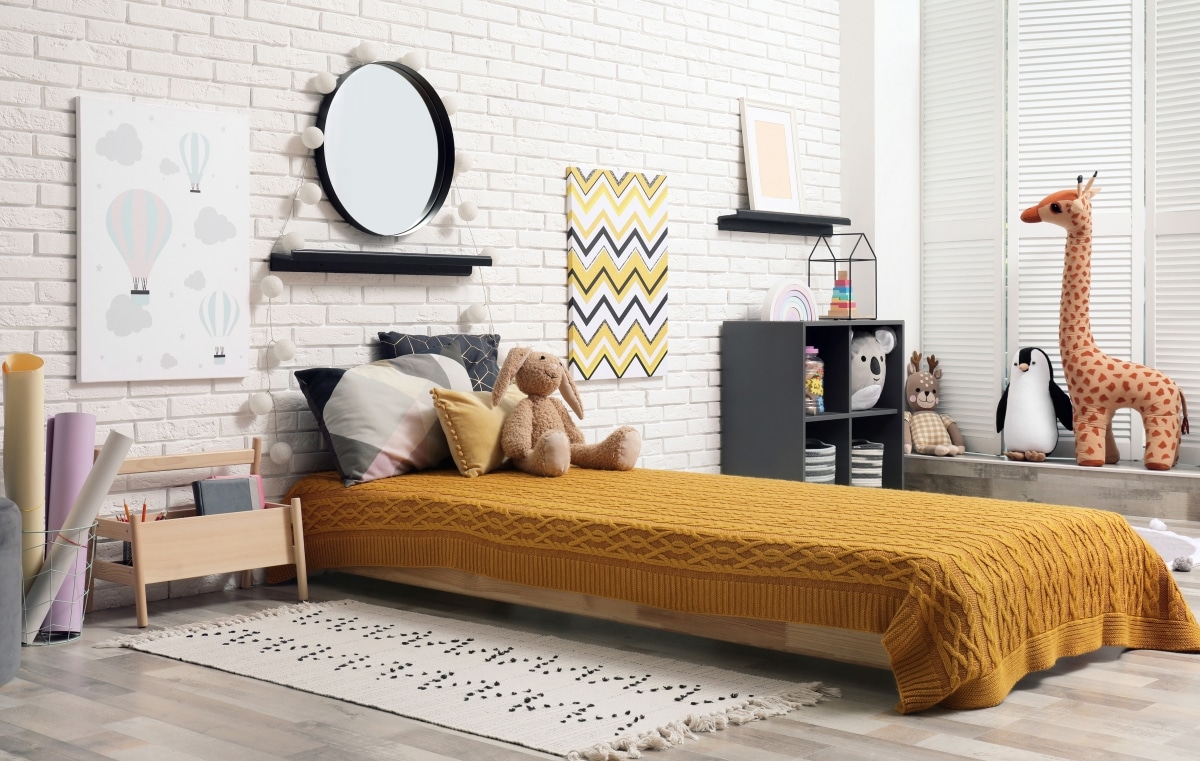 patterned bedding, rug, and wall hanging in kids room