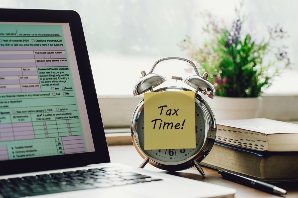 A laptop showing forms for tax filing.