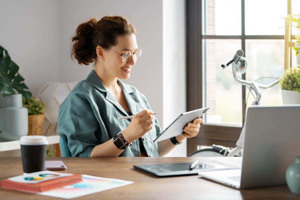 A woman working on graphic designs for a small business.