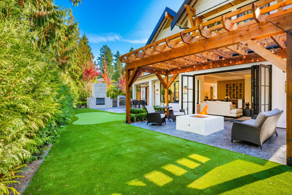 outdoor lounge area with fire pit under a pergola