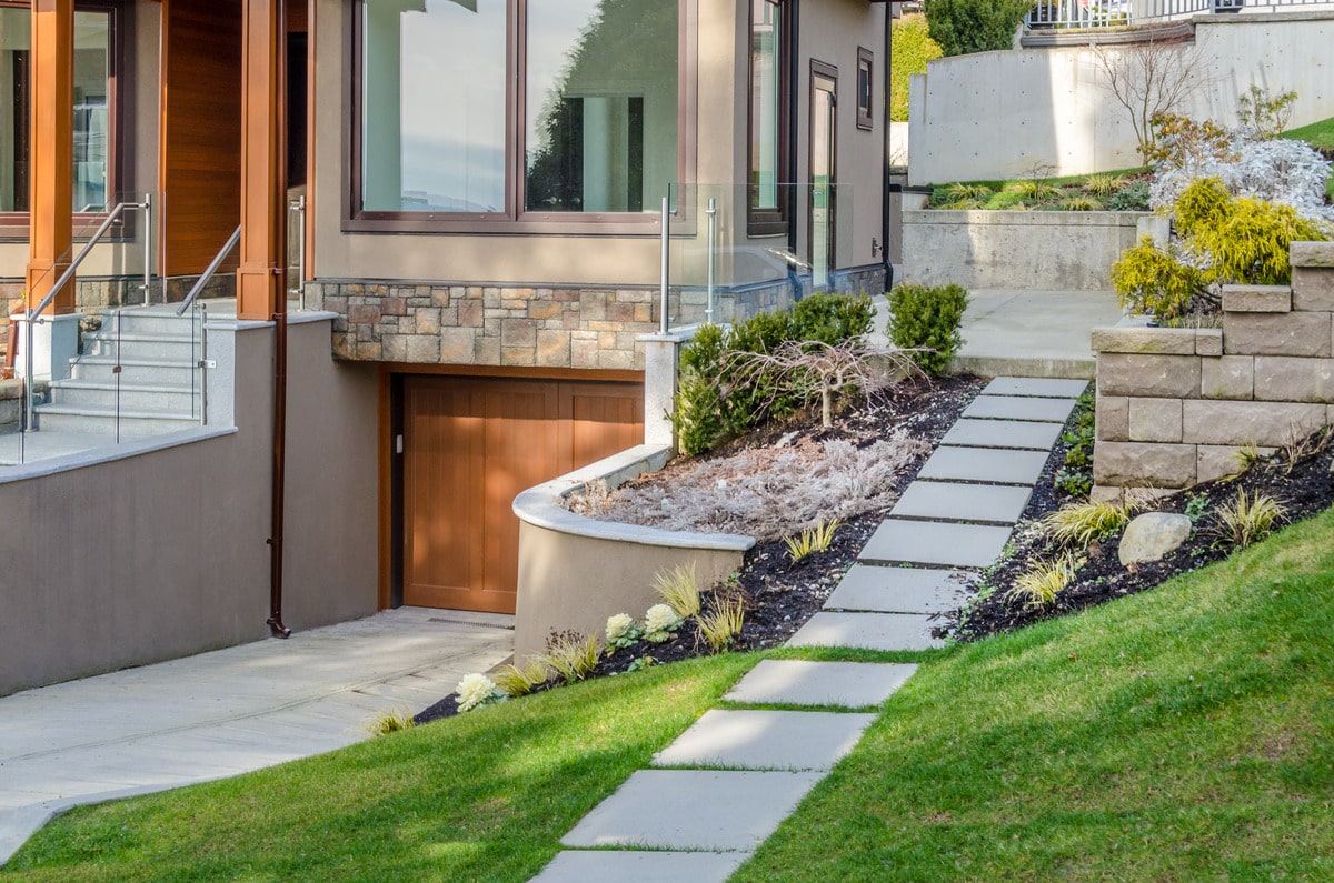 stone stairs leading to a house with outdoor landscape
