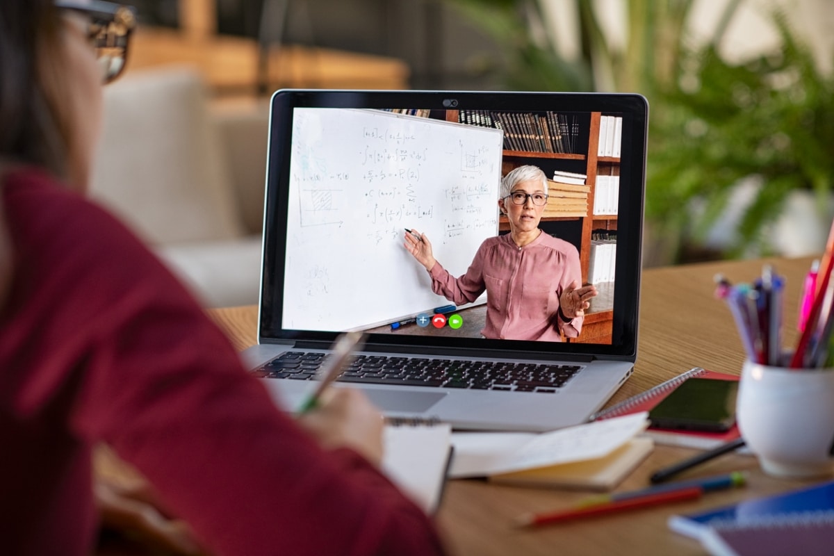 Student watching lesson online and studying from home.