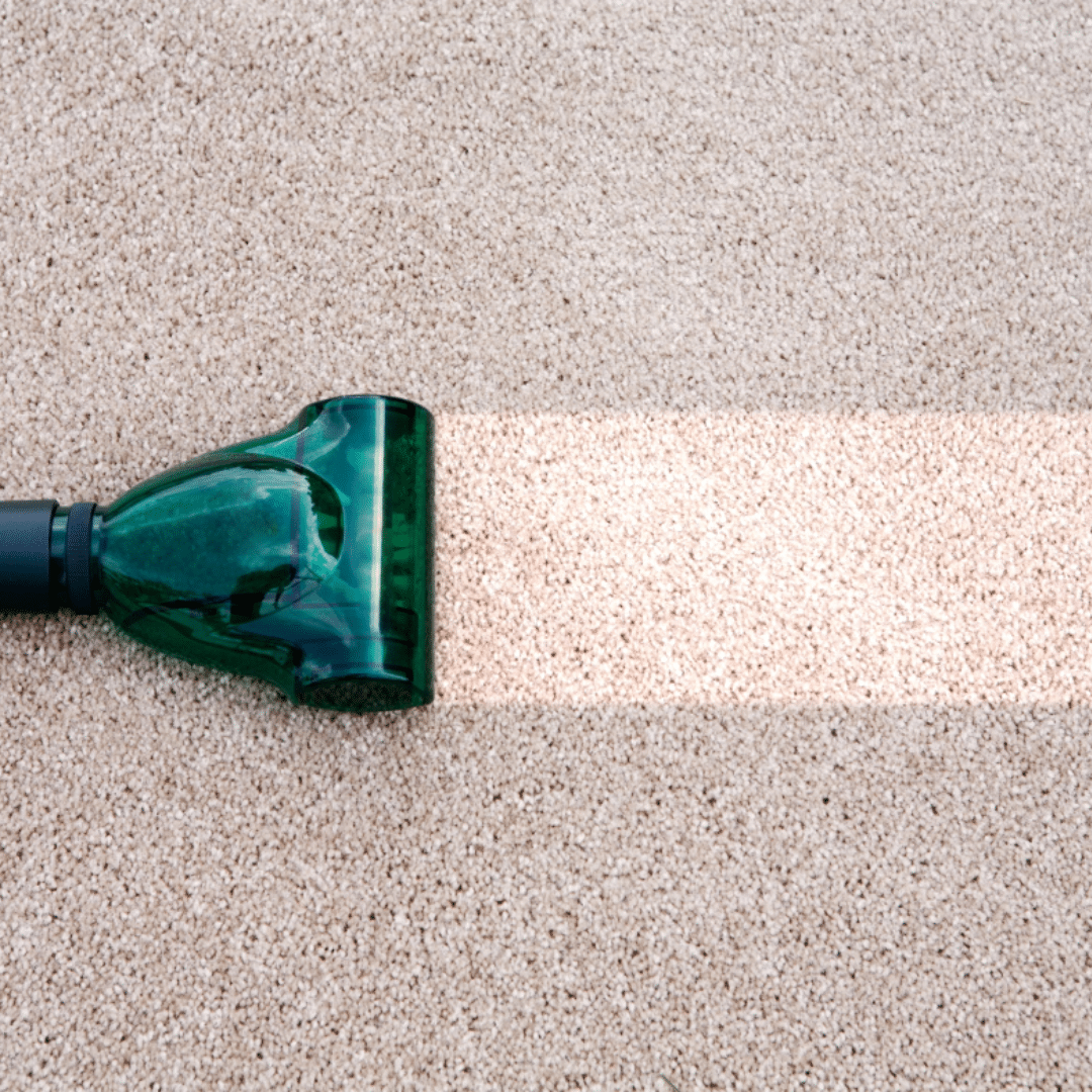 vacuuming a dirty carpet