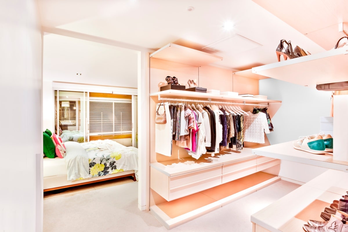 bedroom attached to dressing room with light pink walls