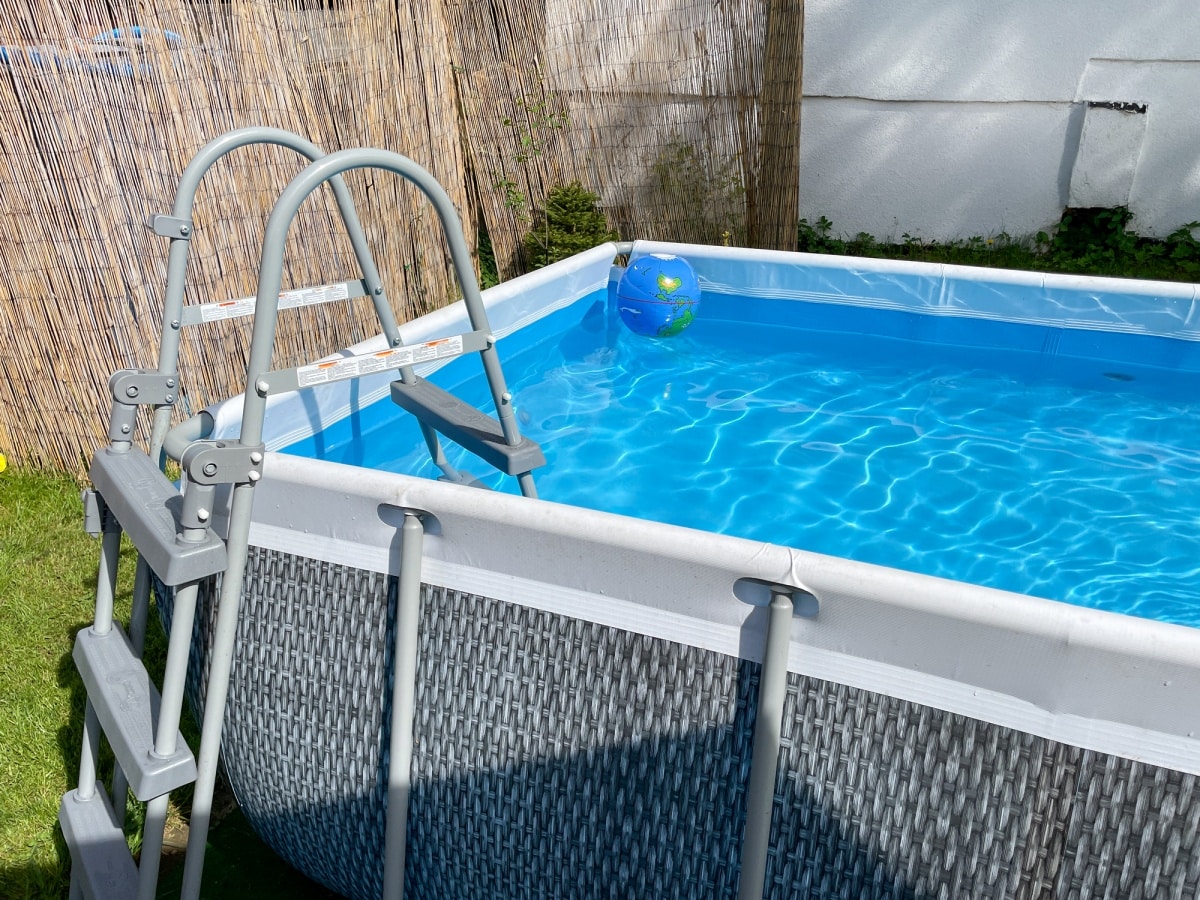 closeup of a garden pool near a thatched fence