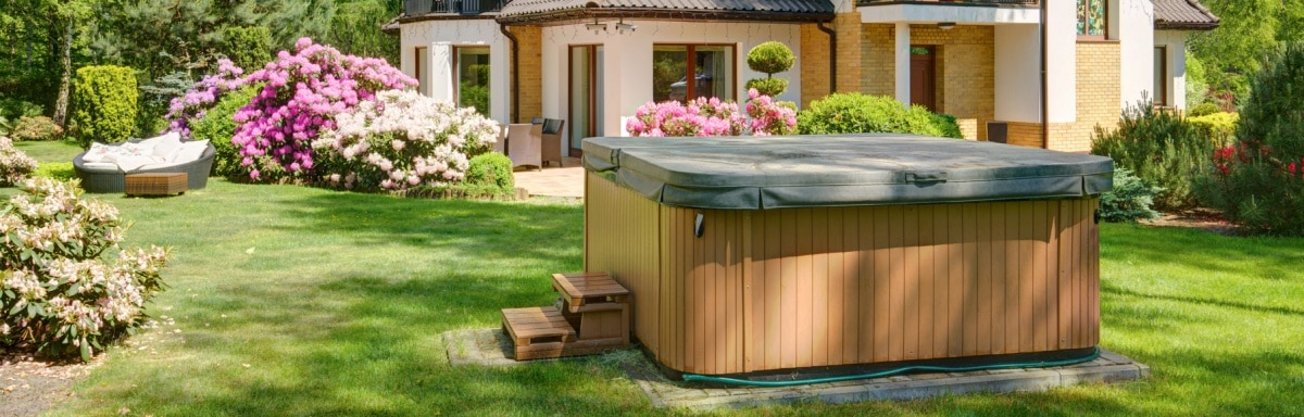 Small covered garden swimming pool in a grassy garden