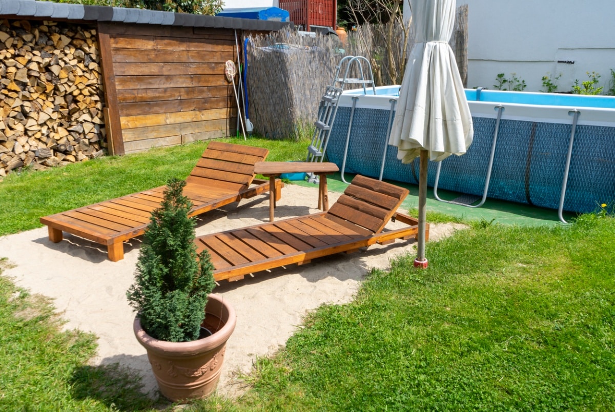 sun loungers in a garden with garden pool