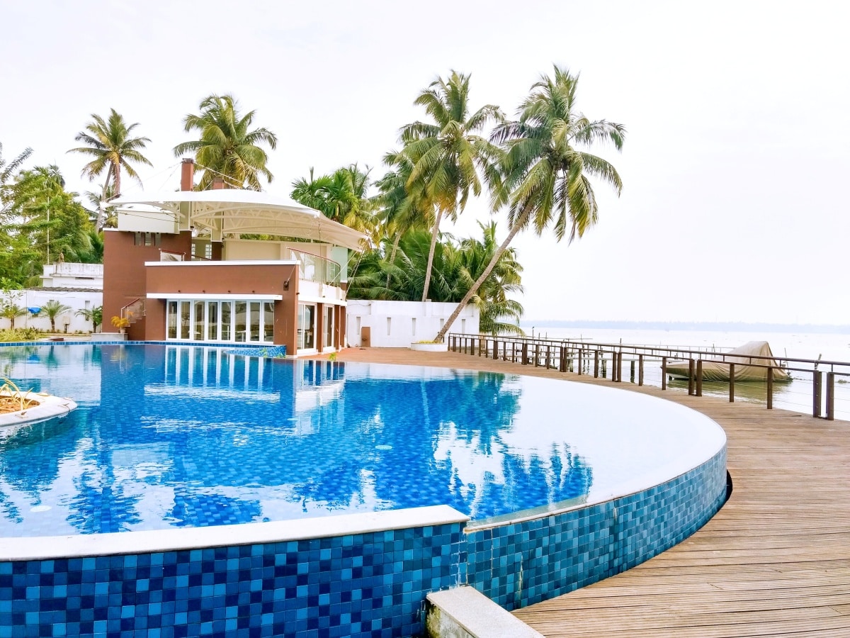 swimming pool near palm trees during daytime