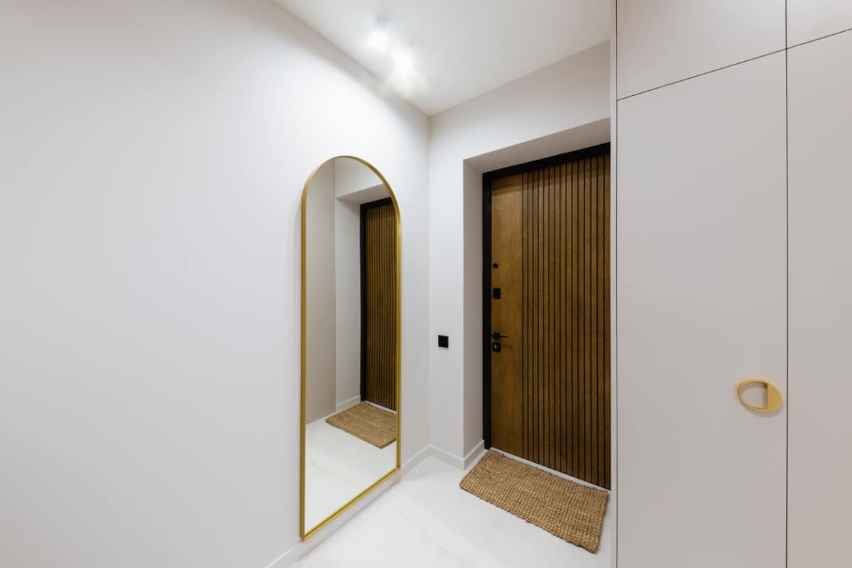 arched mirror in narrow hallway