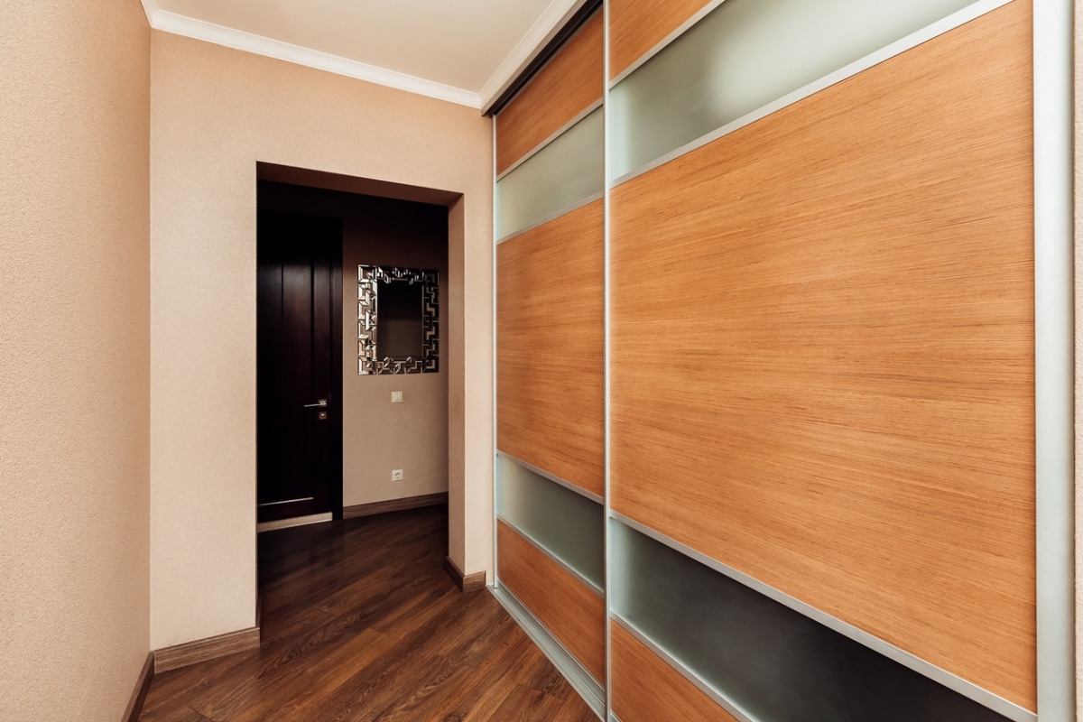 narrow hallway with sliding door storage