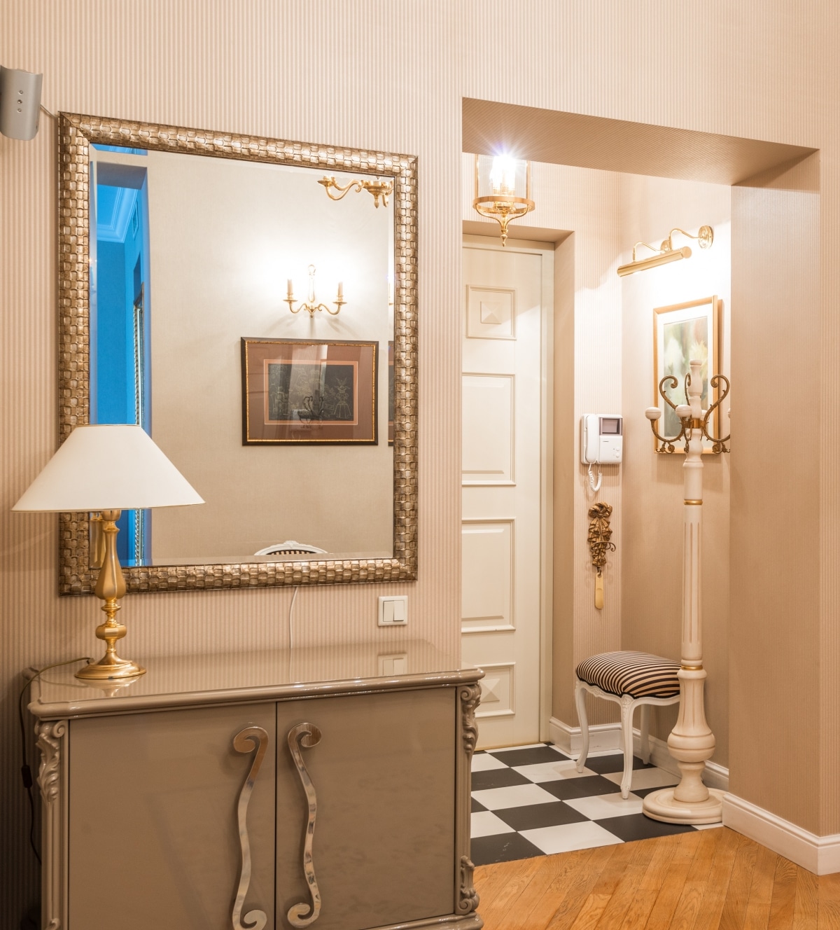 elegant narrow hallway with gold furniture