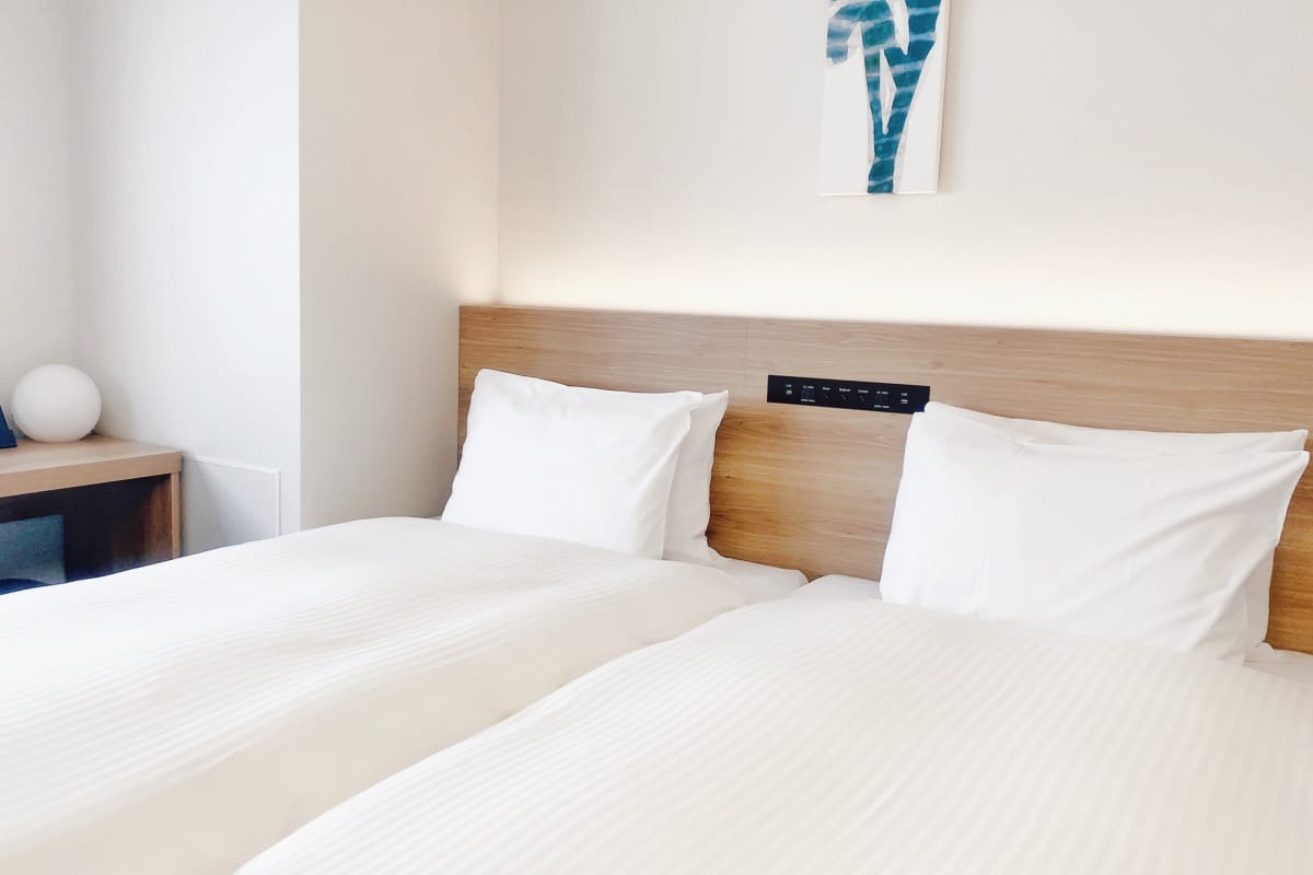 Wooden bed headboard with built-in plugs for various kinds of cords