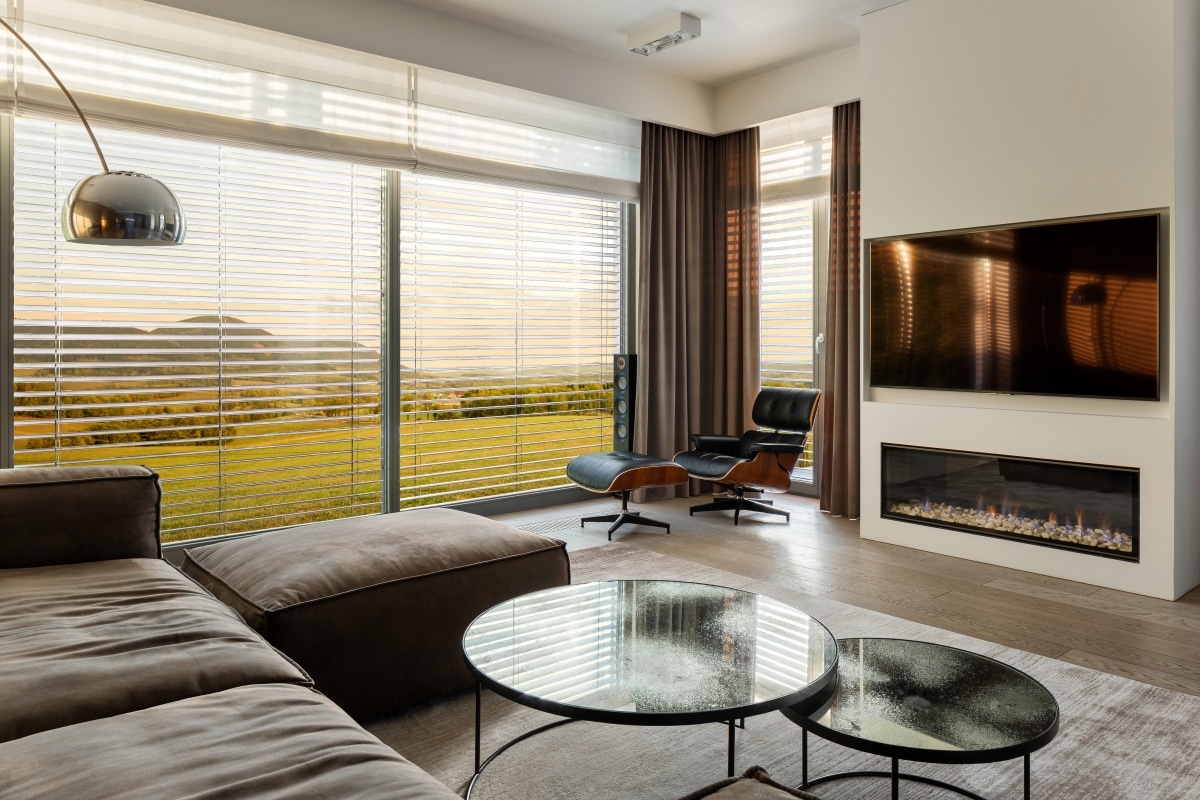 luxury living room with fireplace and tv wall