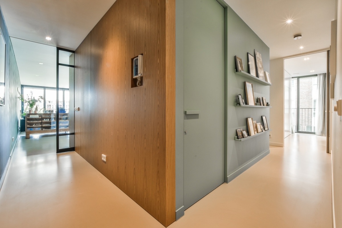 Interior of a bright hallway with shelves for frames