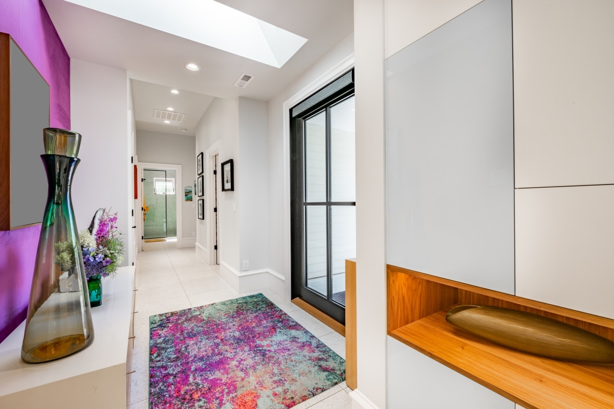 colourful entryway with purple rug and wall
