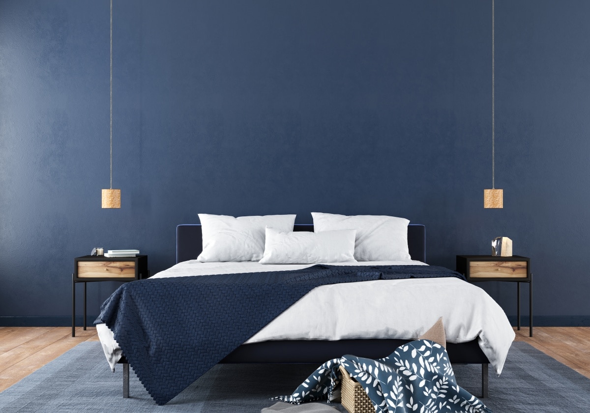 Modern bedroom interior with a stylish combination of trendy blue and light wood texture