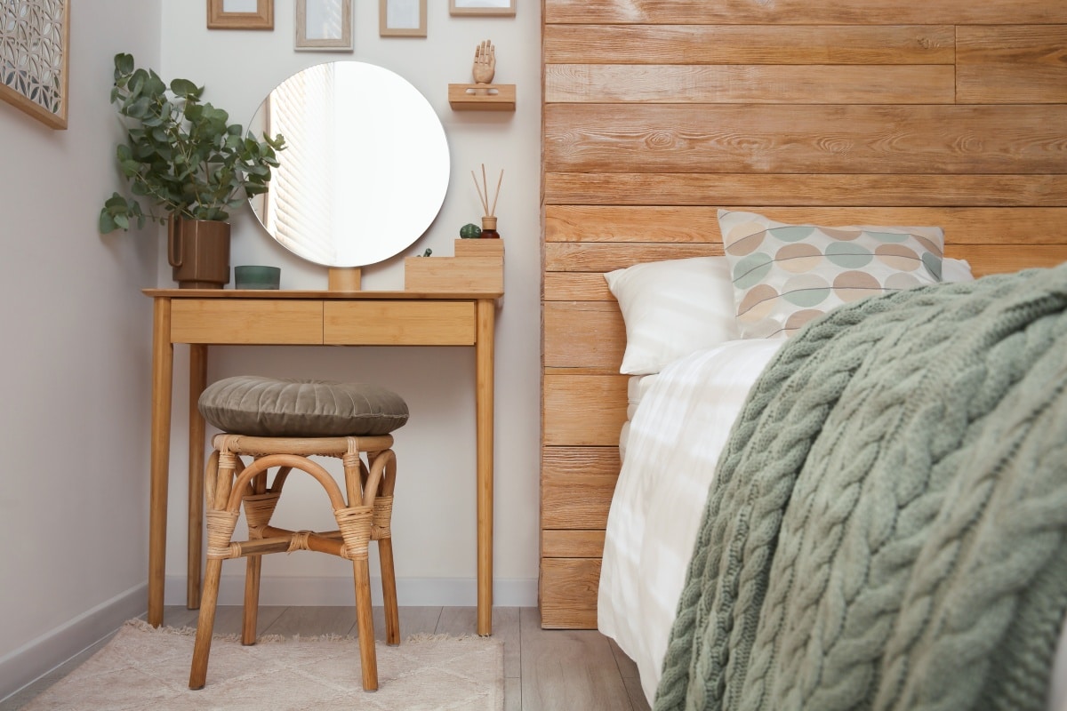 Stylish dressing table and mirror near white wall in bedroom