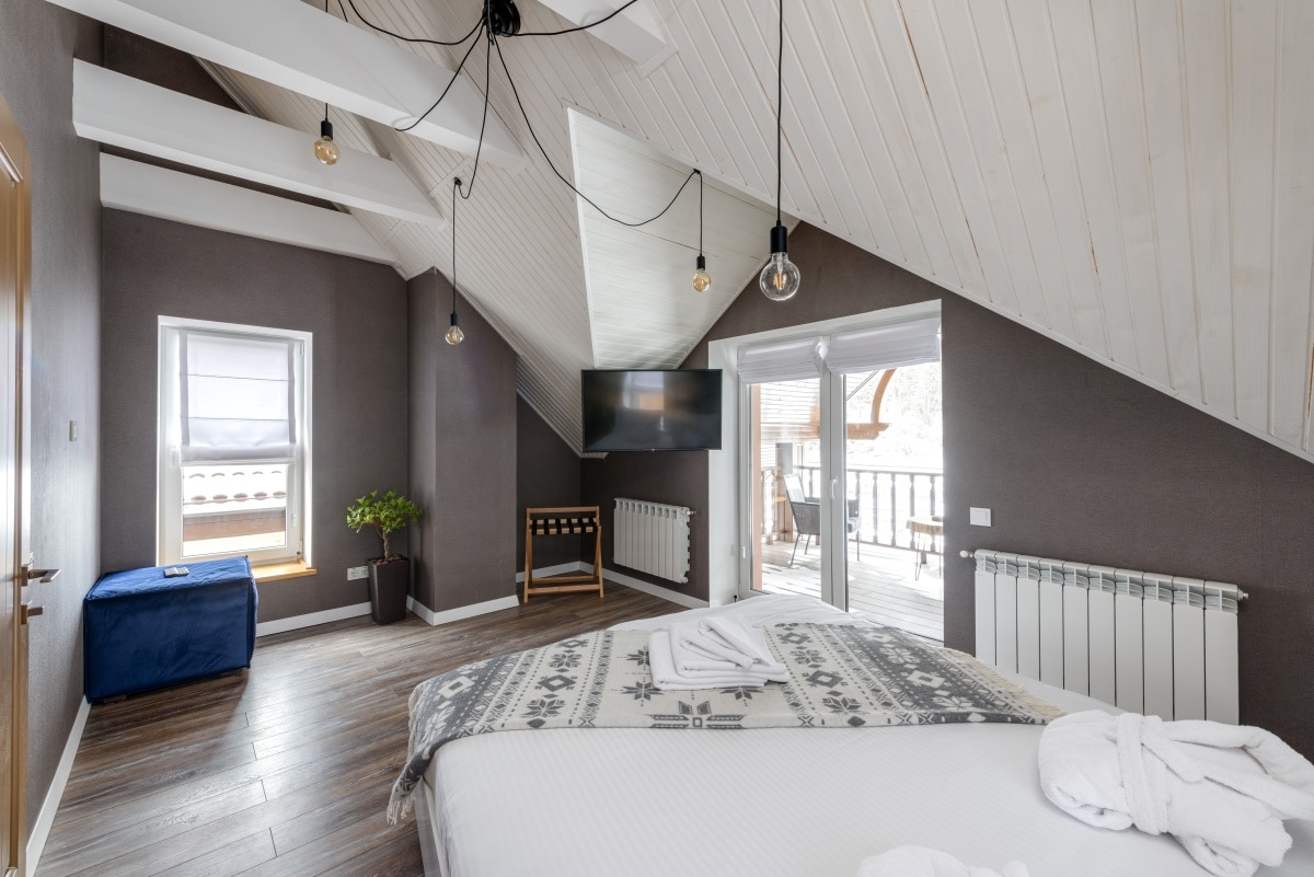 An interior of a bedroom with filament light bulbs as feature pendants