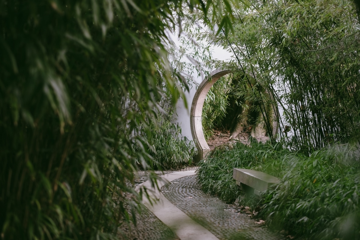 circular garden entrance hidden behind trees
