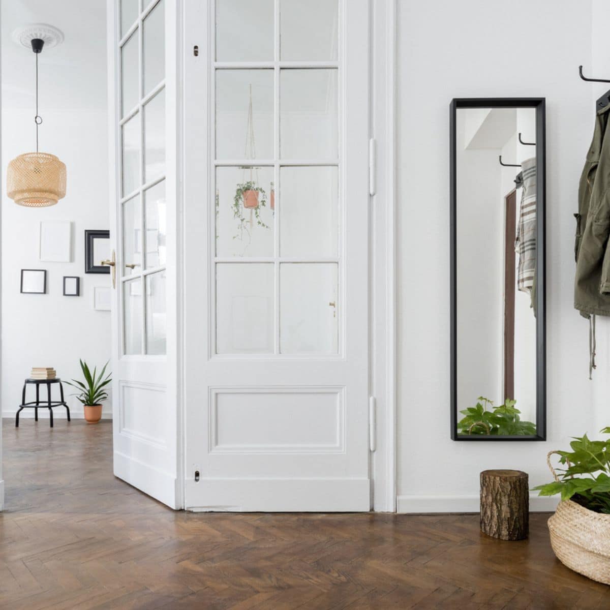 a white hallway with brown laminated flooring