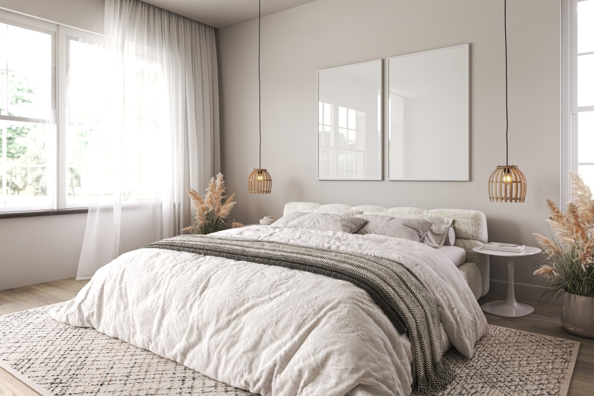 boho bedroom interior with wooden floor, sheer curtains, and white bed