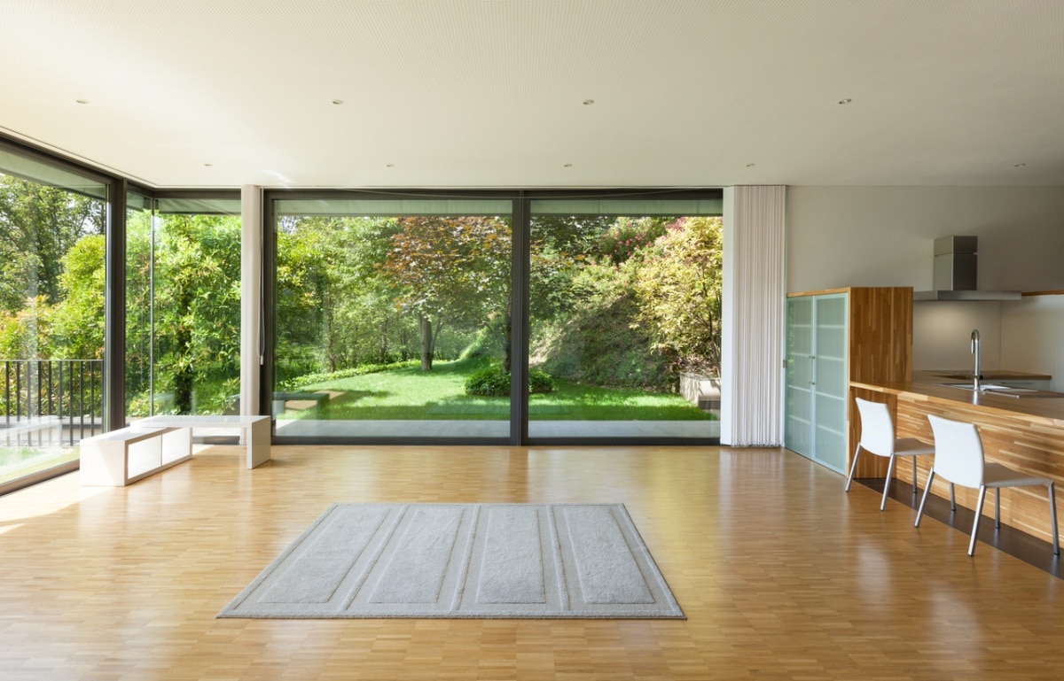 house with wide living room and windows overlooking natural scenery