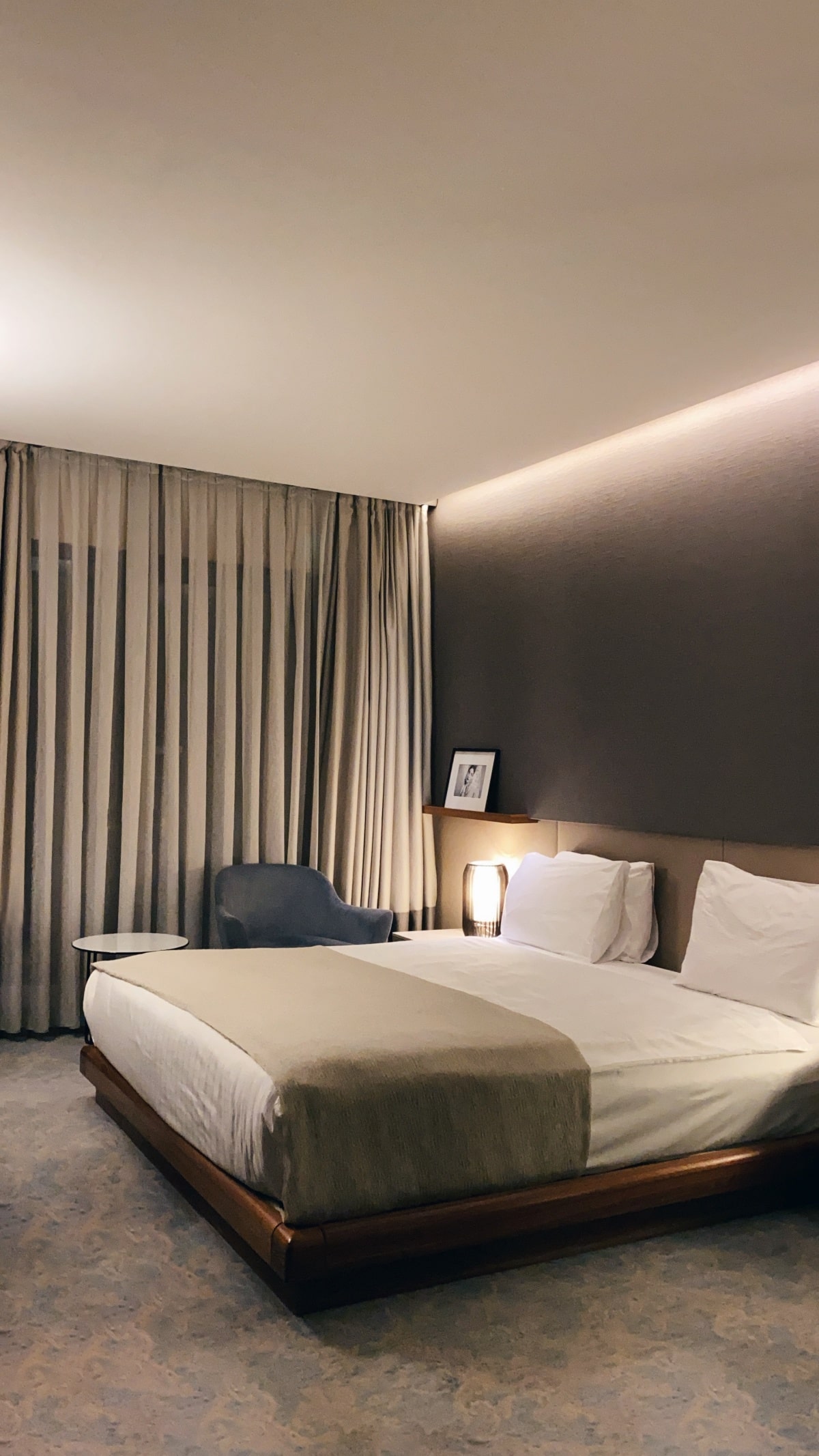 Grey and white bedroom with floor-to-ceiling curtains