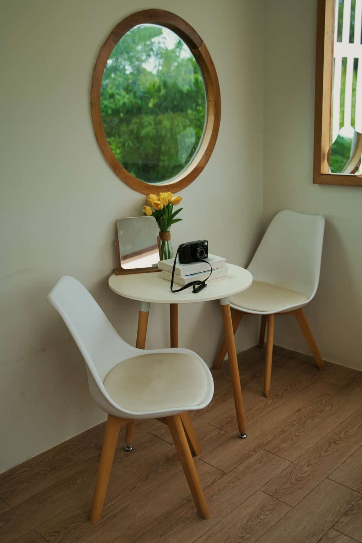 Interior with a Circular Window, a Table and Chairs