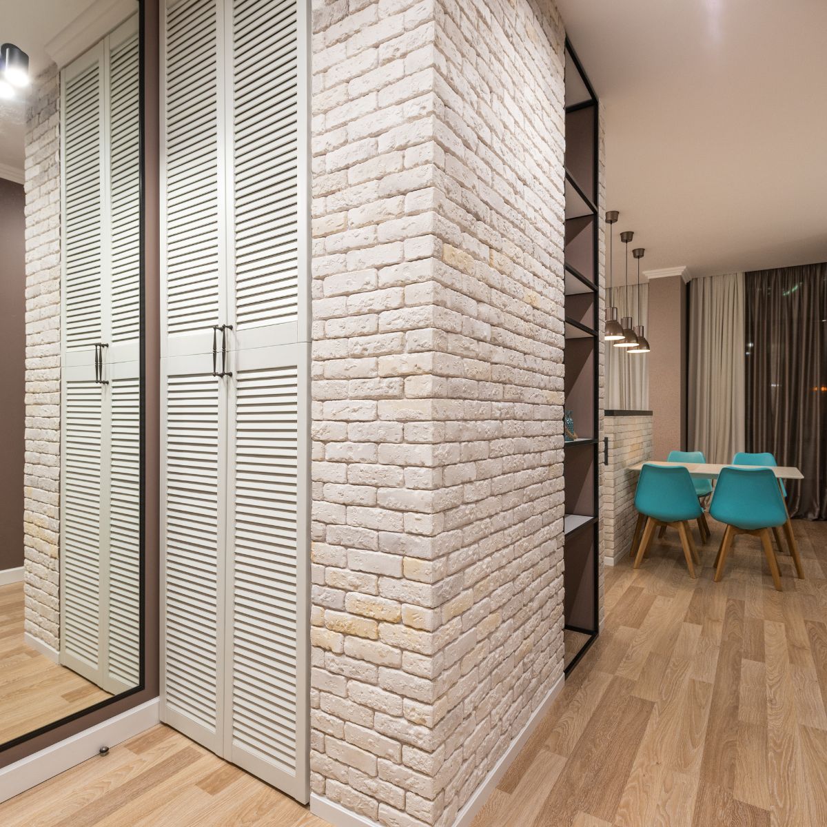a hallway with a brick pattern on the closet