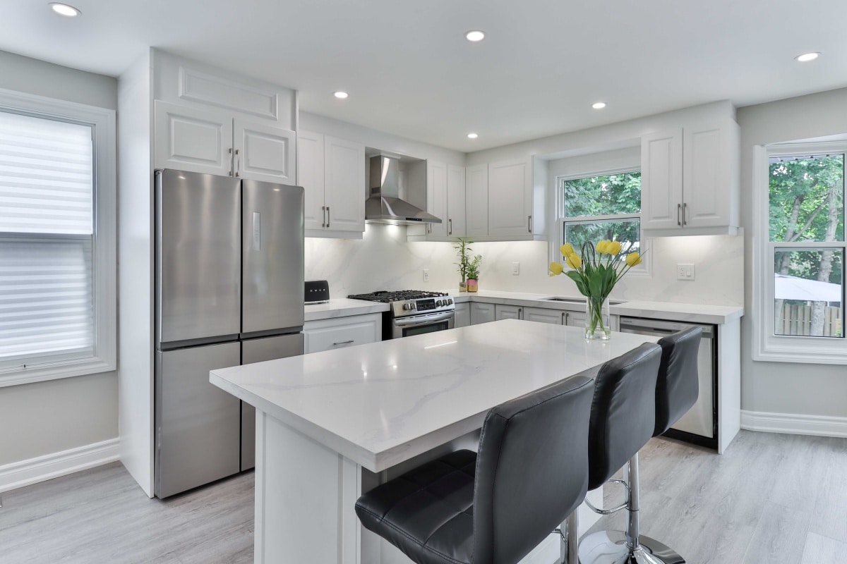 a kitchen with a window and sink on a marble bench
