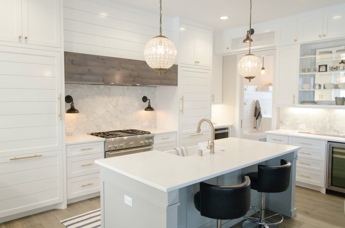 All-white kitchen with black barstools