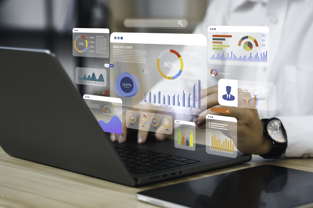 An analyst uses a computer and dashboard for data business analysis