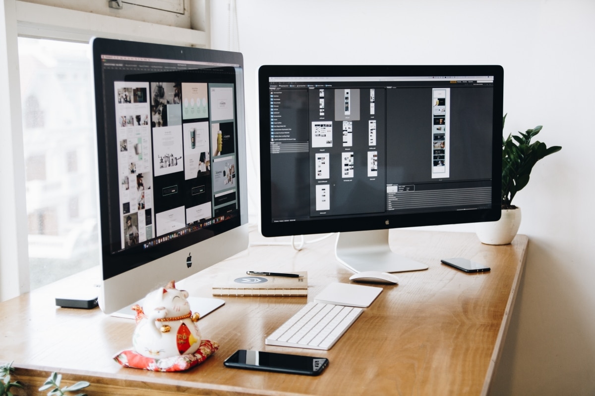two monitors on a work desk
