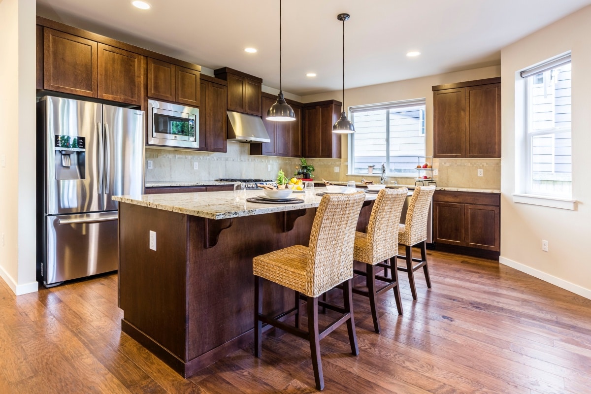 Brown kitchen cabinets with wooden kitchen island