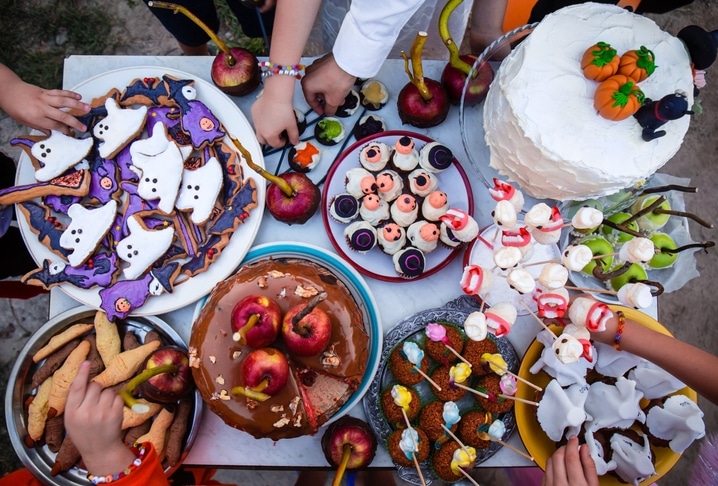 A table spread of Halloween snacks for a party.