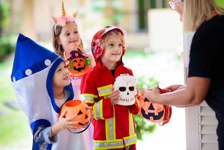 Kids wearing costumes and trick-or-treating during Halloween.