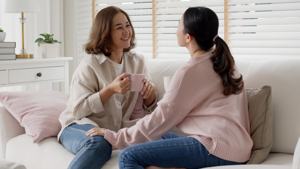 Things to do on Mother’s Day, Mother and grown up daughter talking and spending quality time on couch